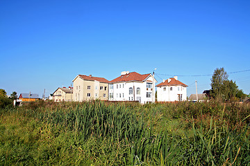 Image showing new cottages near green marsh