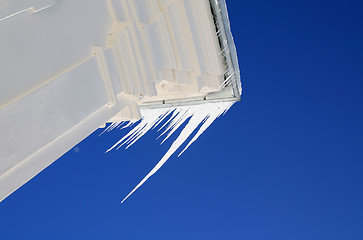 Image showing white icicles on roof of the building