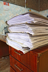 Image showing heap of the papers on table in office