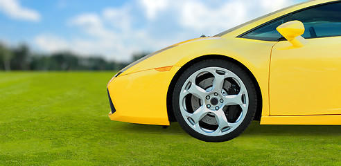 Image showing Yellow Luxury Sport Car outdoor on green grass