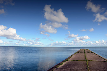 Image showing Concrete pier or bridge in sea. Calm sea water. 