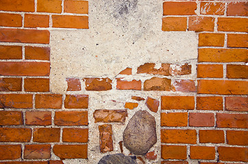 Image showing Fragment of ancient red brick wall with stones ant cement in it. 