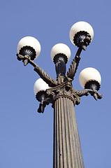 Image showing Antique lamp with five large bubbles in park.