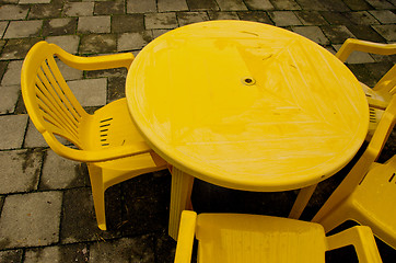 Image showing Yellow plastic table and chairs for outdoor relax. 