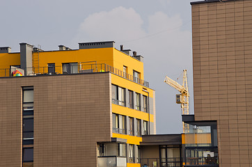 Image showing Modern houses and crane between it. Construction. 