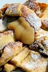 Image showing  Cut-up and sugared pancake with raisins