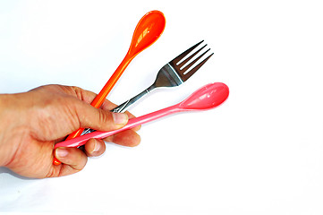 Image showing Spoons and fork in hand