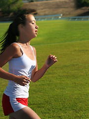 Image showing Teen girl running on the stadium