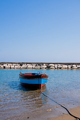 Image showing Small fishing boat floating on the water 