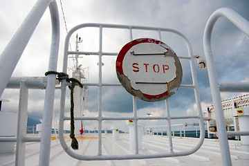 Image showing Sign Stop on a gate on boat