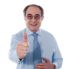 Image showing Smiling mature businessman showing thumbs-up