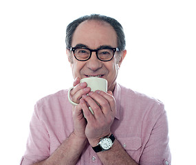 Image showing Senior man smiling and enjoying coffee