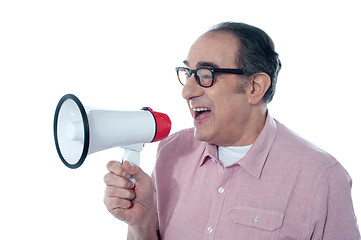 Image showing Elder casual man shouting through megaphone