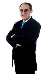 Image showing Welldressed company director posing with folded arms