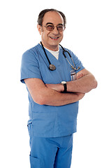 Image showing Smiling matured doctor posing with folded arms