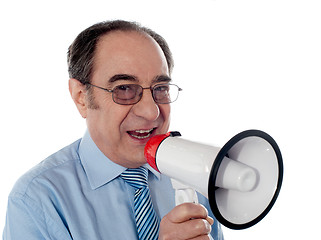 Image showing Elderly businessman making an announcement