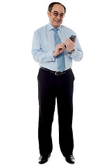 Image showing Handsome old corporate man using cellphone