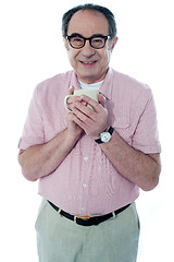 Image showing Old man holding a coffee mug