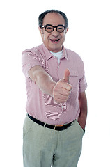 Image showing Smiling aged male gesturing thumbs-up