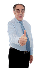 Image showing Happy senior manager posing with thumbs-up gesture