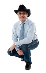 Image showing Image of a senior cowboy posing semi seated