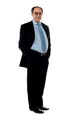 Image showing Full pose of a smiling senior company director