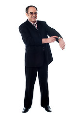 Image showing Senior businessman pointing towards wrist watch