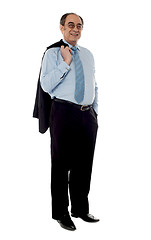 Image showing Senior businessman holding coat over his shoulders