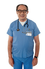Image showing Handsome smiling senior doctor posing in front of camera