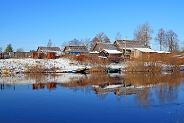 Image showing boats near villages on coast river 