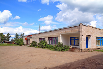 Image showing gray brick building on rural street