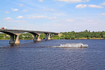 Image showing small promenade motor ship on big river near bridge