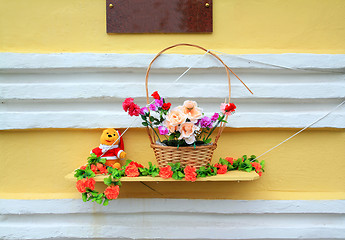 Image showing red flowerses on yellow wall