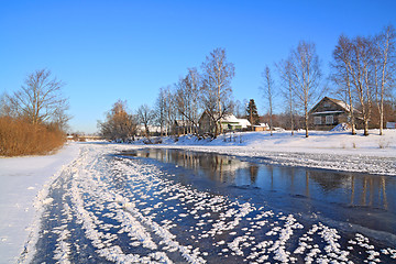 Image showing winter village on coast river 