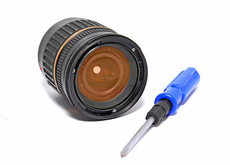Image showing lens and screwdriver on white background