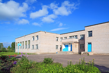 Image showing gray brick building on rural street