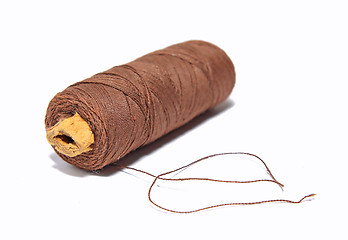 Image showing spool  brown threads on white background