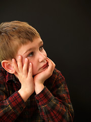 Image showing boy resting face in hands