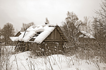 Image showing old wooden house amongst winter snow