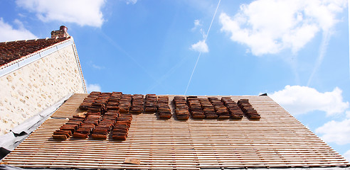 Image showing renovation of a tiled roof of an old house