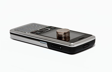 Image showing cell phone and a column of coins