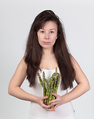 Image showing The young beautiful woman with the fresh vegetables