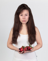 Image showing The young beautiful woman with the fresh strawberries