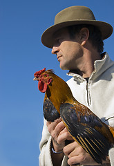 Image showing man and rooster