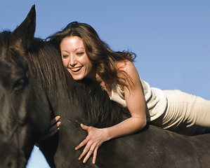 Image showing laughing woman and stallion
