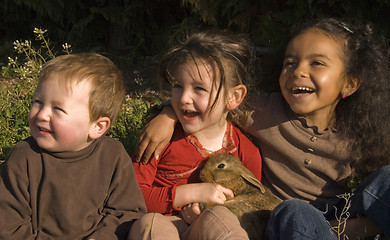 Image showing three children and bunny