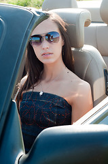 Image showing Woman in sunglasses sitting in cabrio