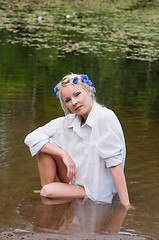 Image showing Shot of beautiful woman sitting on water