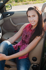 Image showing Beautiful brunette woman sitting in cabrio