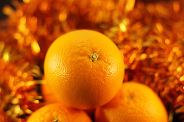 Image showing orange close up on a background of twinkling garlands